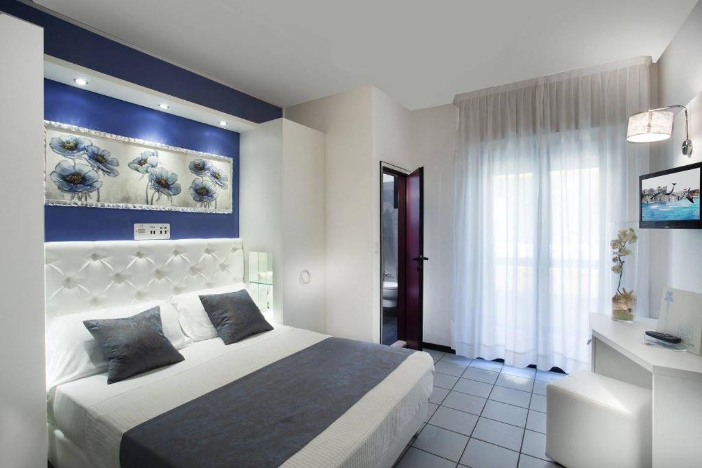 Postel nebo postele na pokoji v ubytování Hotel Ambassador