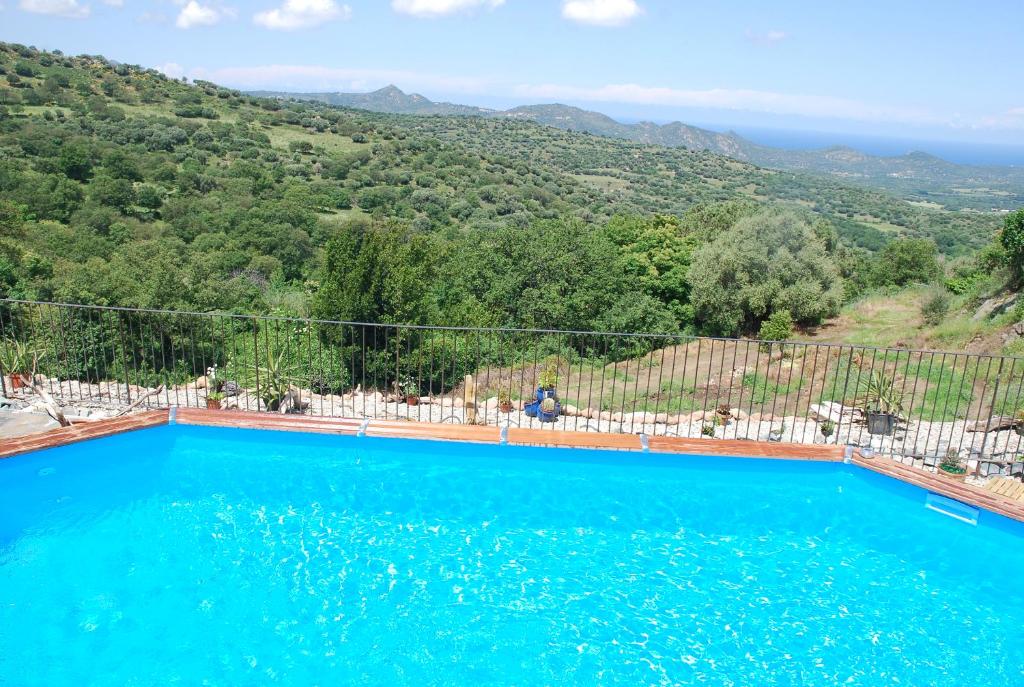 a swimming pool with a view of a mountain at costa di sognu in Costa