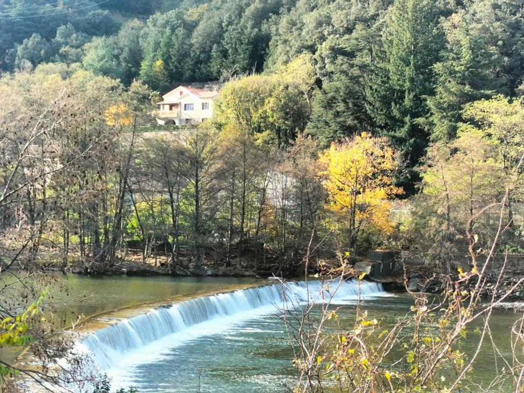 a waterfall in the middle of a river at L'Ardéchois in Vals-les-Bains