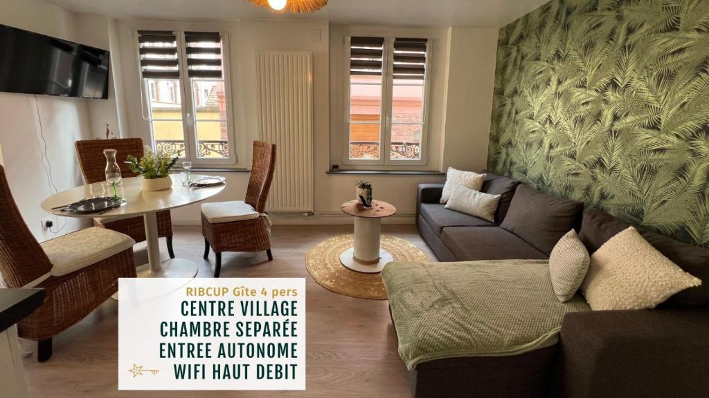 a living room with a couch and a table at Gîte Ripcup au coeur de Ribeauvillé in Ribeauvillé