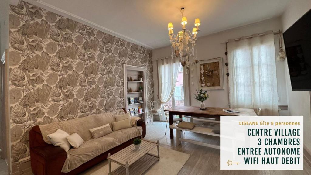 a living room with a couch and a table at GITE AU COEUR DU VIGNOBLE ALSACIEN in Ribeauvillé