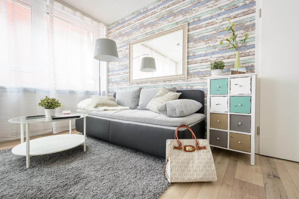 a living room with a couch and a table at Deluxe Appartements am Münster in Freiburg im Breisgau