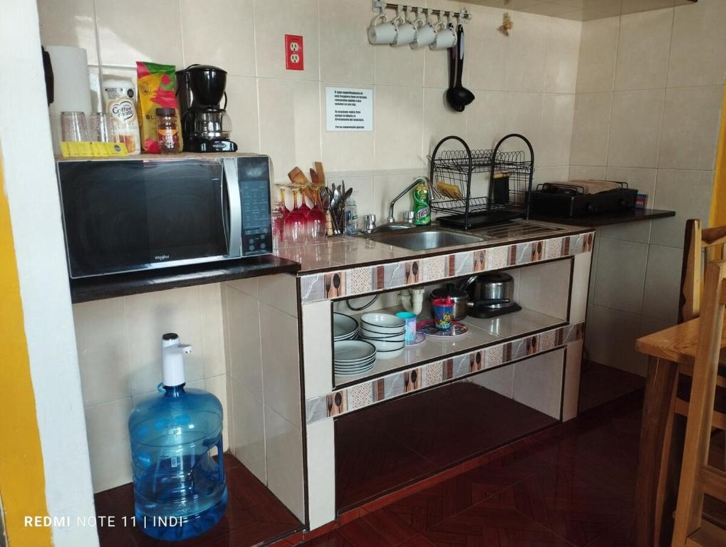 eine Küche mit Mikrowelle und Spüle in der Unterkunft casa brisa marina in Isla Mujeres