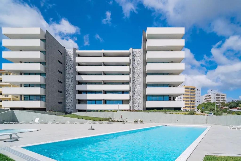 a swimming pool in front of a building at Summer Days in Lagos