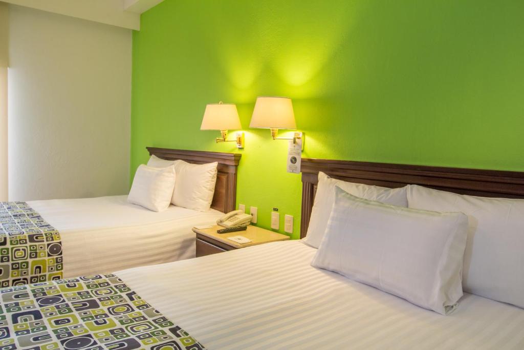 Postel nebo postele na pokoji v ubytování HG Hotel