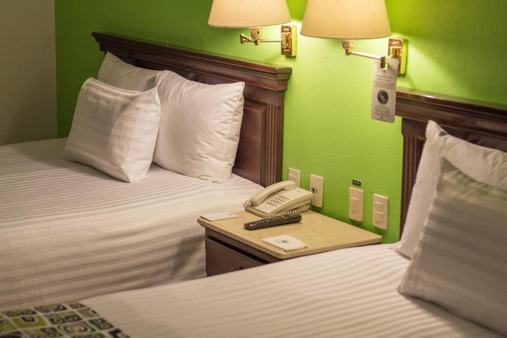 Postel nebo postele na pokoji v ubytování HG Hotel