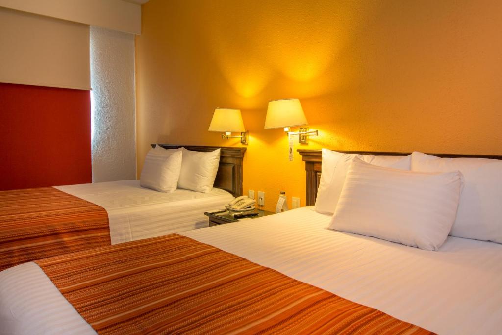 Postel nebo postele na pokoji v ubytování HG Hotel