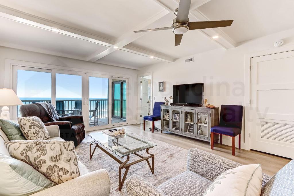 a living room with a couch and a tv at High End Coastal Feel Condo in Fernandina Beach