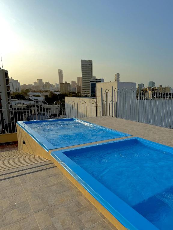 a blue swimming pool on the roof of a building at Hotel Caribe Plaza Barranquilla in Barranquilla