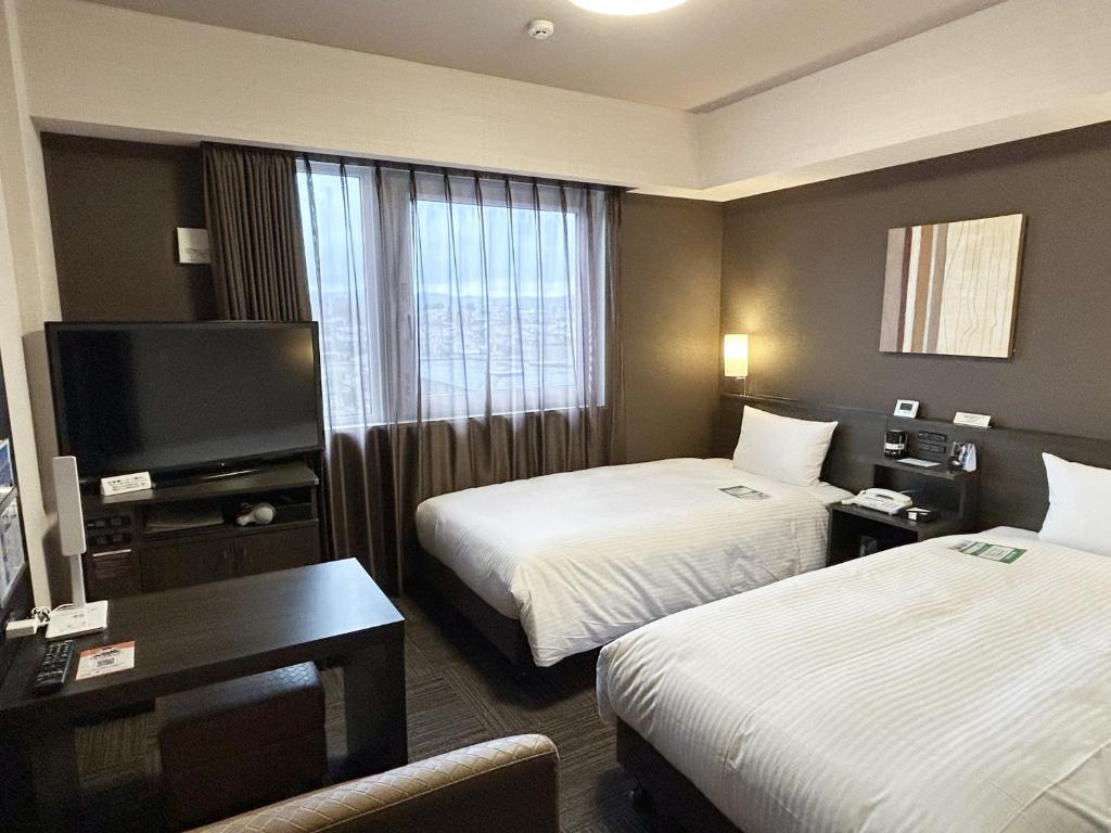 Postel nebo postele na pokoji v ubytování Hotel Route-Inn Sabae -Kokudou 8 Gou-