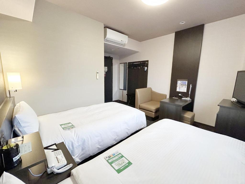 Postel nebo postele na pokoji v ubytování Hotel Route-Inn Sabae -Kokudou 8 Gou-