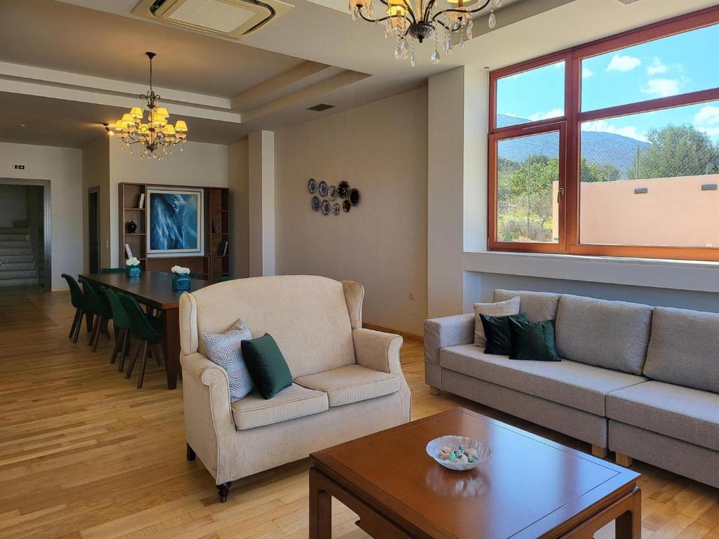 a living room with a couch and a table at Villa in Hersonissos by Sandy Beach & Pool in Hersonissos