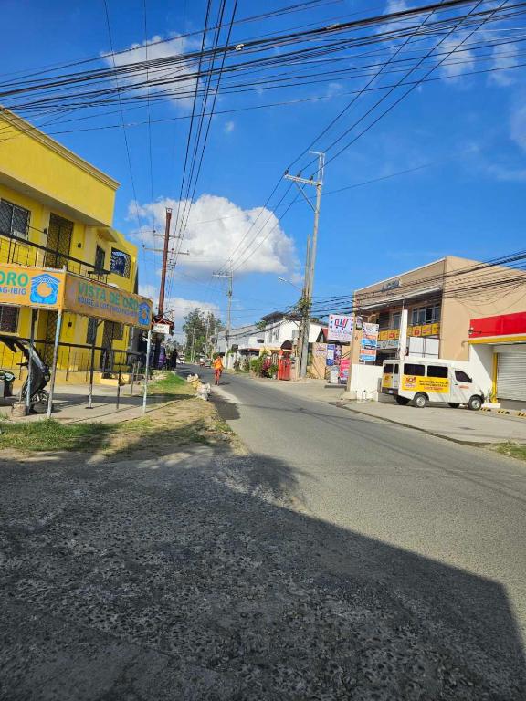 an empty street in a small town with buildings at Mel's Place Batangas Unit 4 Vista De Oro 2 Bedroom House w Free Parking, Google TV WIFI Netflix 4 Guests in Batangas City