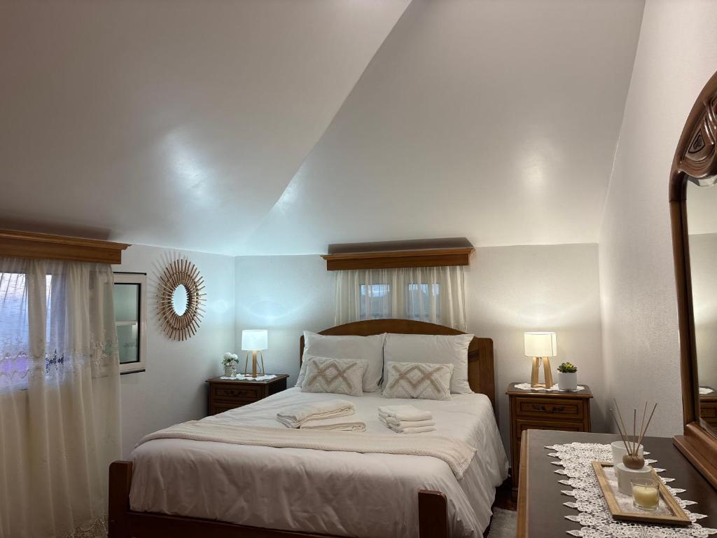 a bedroom with a bed with two towels on it at Maria apartment in Ponta do Sol