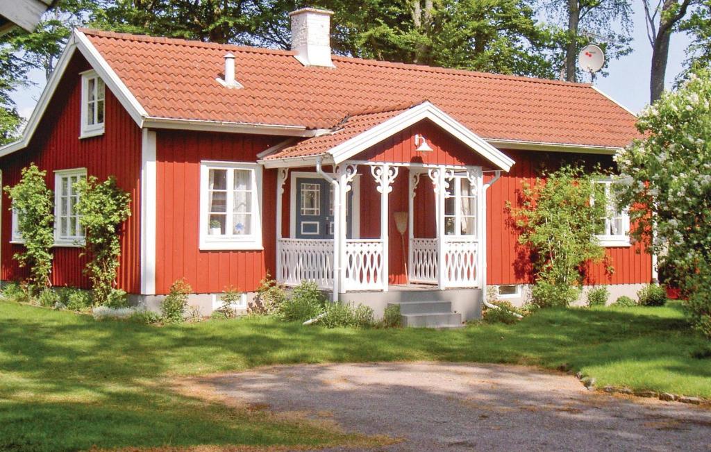 a red house with a red roof at Holiday Home Sjöhagen Ljungby in Bolmstad