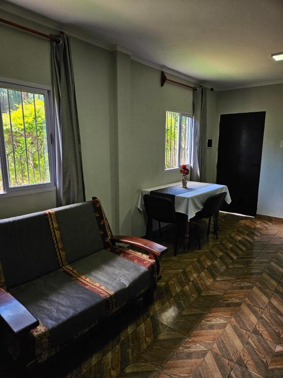 a living room with a couch and a table at Agradable Monoambiente en posadas in Posadas