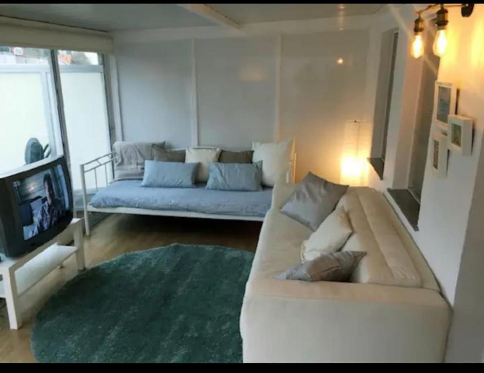 a living room with a couch and a tv at Beautiful apartment Pontevedra in Sanxenxo