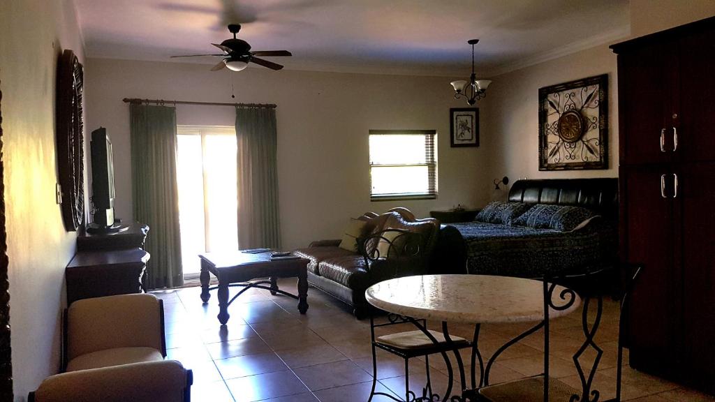 a living room with a couch and a table at Garden Studio At Ocean Dream Resort in Cabarete