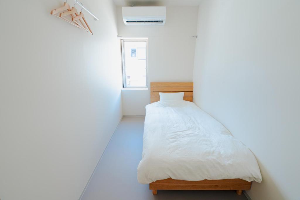 Postel nebo postele na pokoji v ubytování EdoHouse -エドゥハウス-
