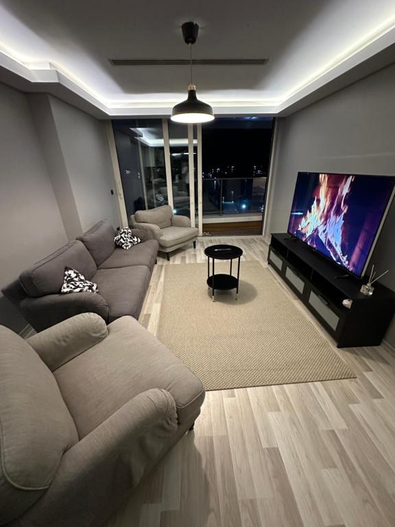 A television and/or entertainment centre at Ottomare Suites luxury apartment with pool with amazing view