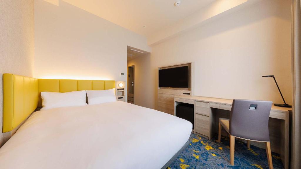 Postel nebo postele na pokoji v ubytování JR-East Hotel Mets Tachikawa