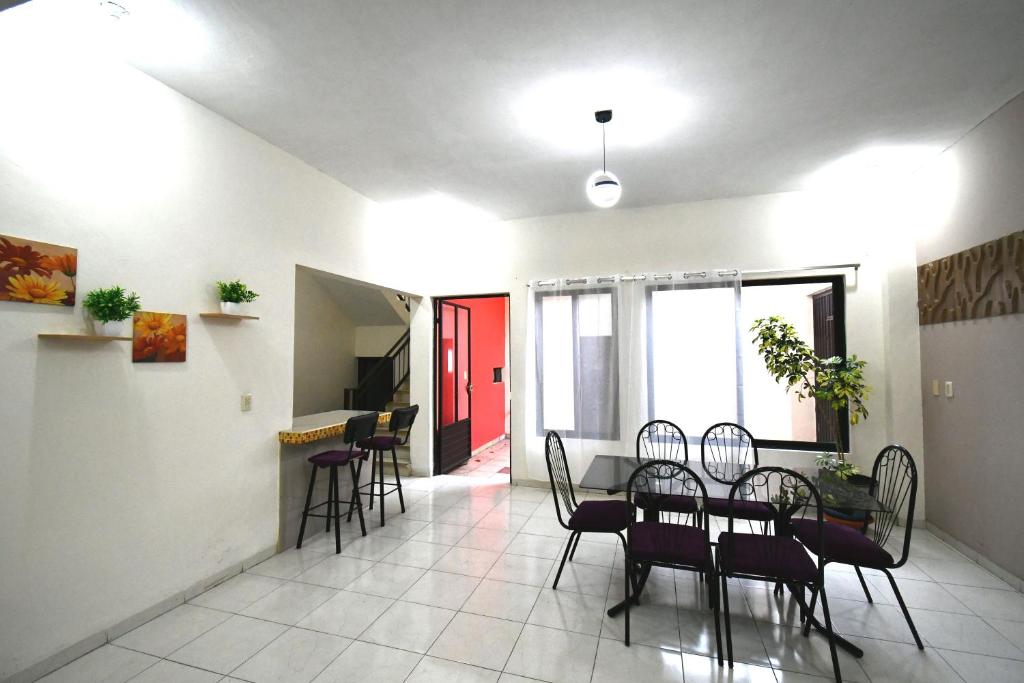 a living room with a dining room table and chairs at Casa La Primavera RTH in Comitán de Domínguez