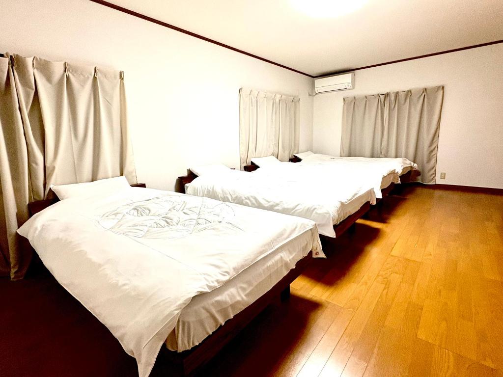 Postel nebo postele na pokoji v ubytování 内宮前別邸 星伊