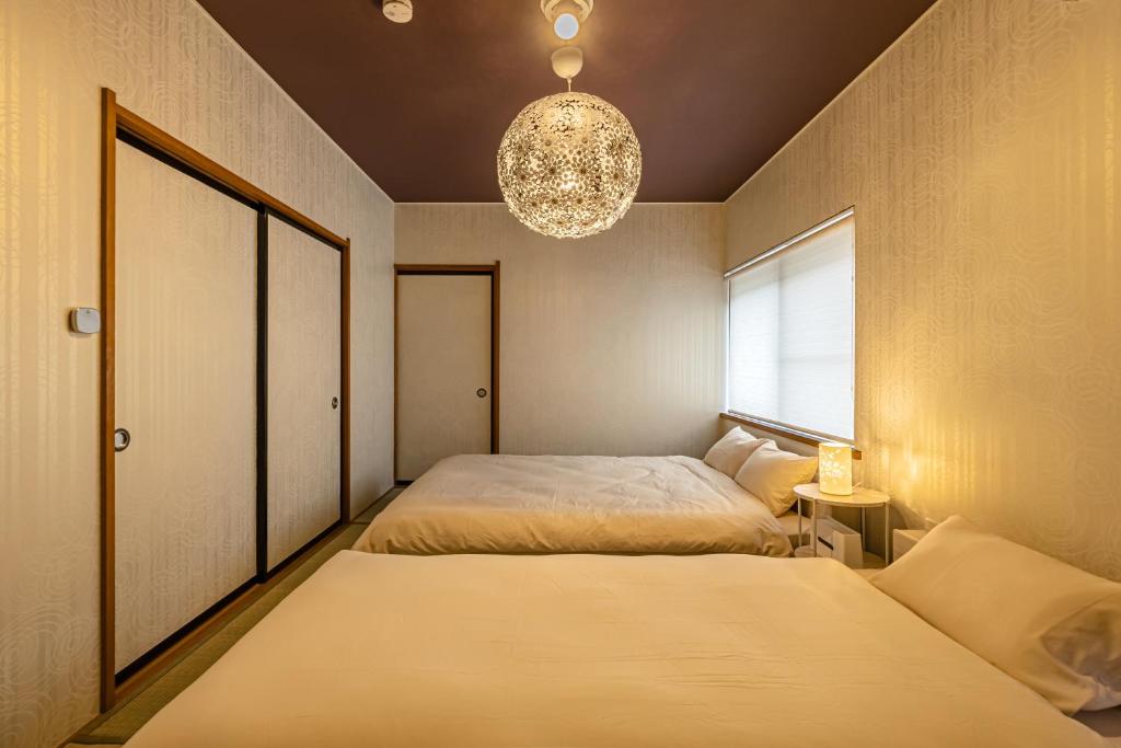 Postel nebo postele na pokoji v ubytování nest Retreat Atami