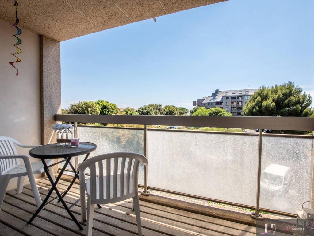un balcon avec une table et des chaises et une vue dans l'établissement T2 Balcon Sud à 50m de la Plage - FR-1-825-38, à La Rochelle