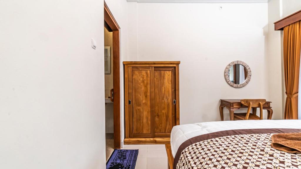 Postel nebo postele na pokoji v ubytování Depi House Ubud