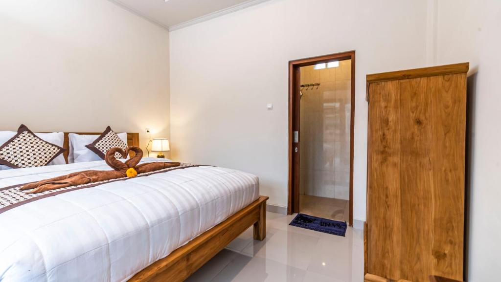 Postel nebo postele na pokoji v ubytování Depi House Ubud