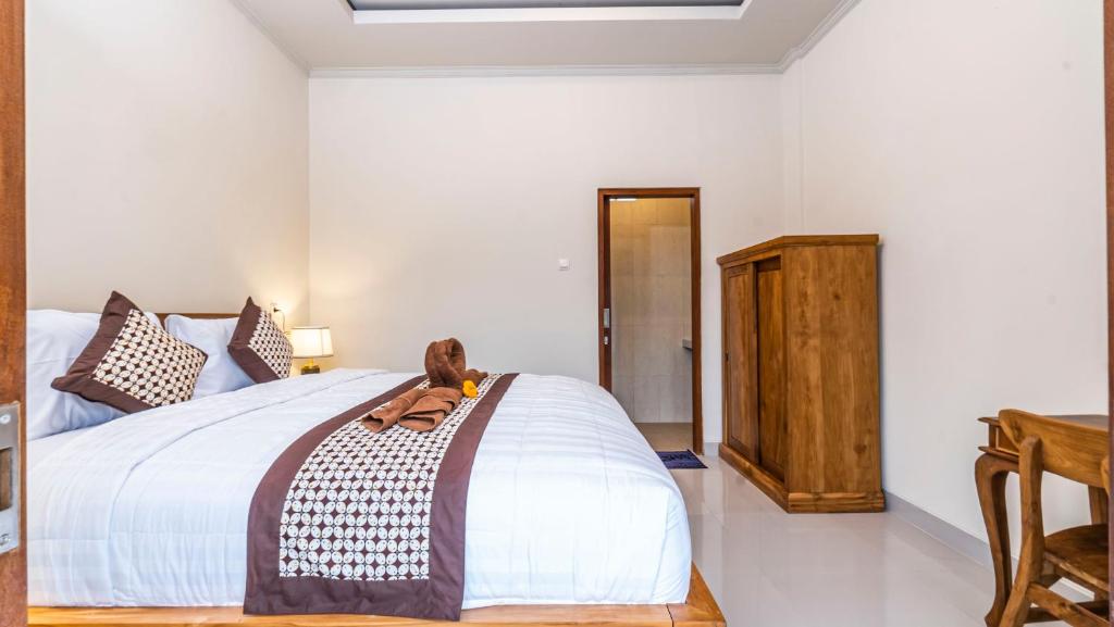 Postel nebo postele na pokoji v ubytování Depi House Ubud