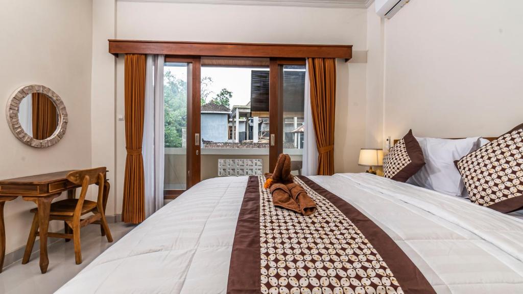 Postel nebo postele na pokoji v ubytování Depi House Ubud