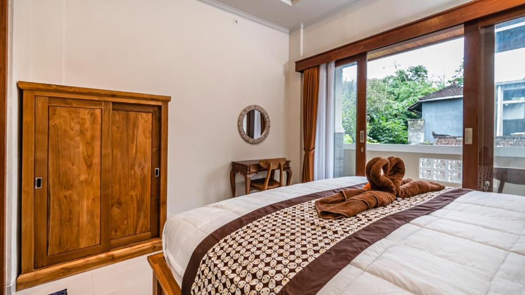 Postel nebo postele na pokoji v ubytování Depi House Ubud