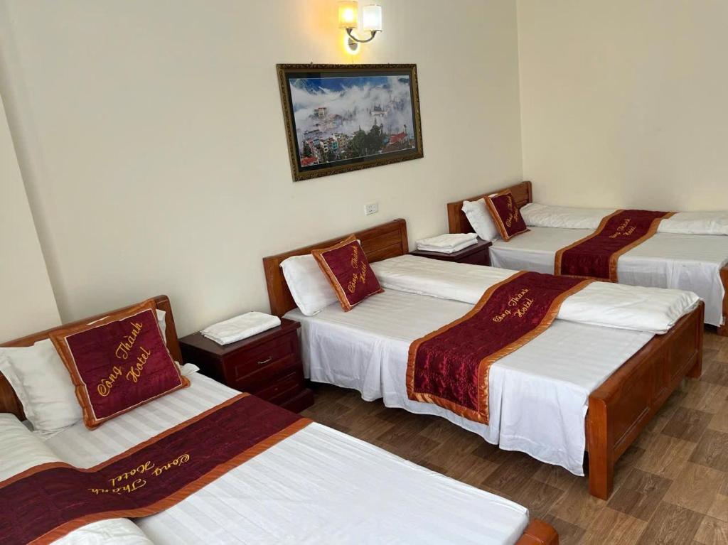 a room with four beds in a room at Công Thành Hotel in Lao Cai