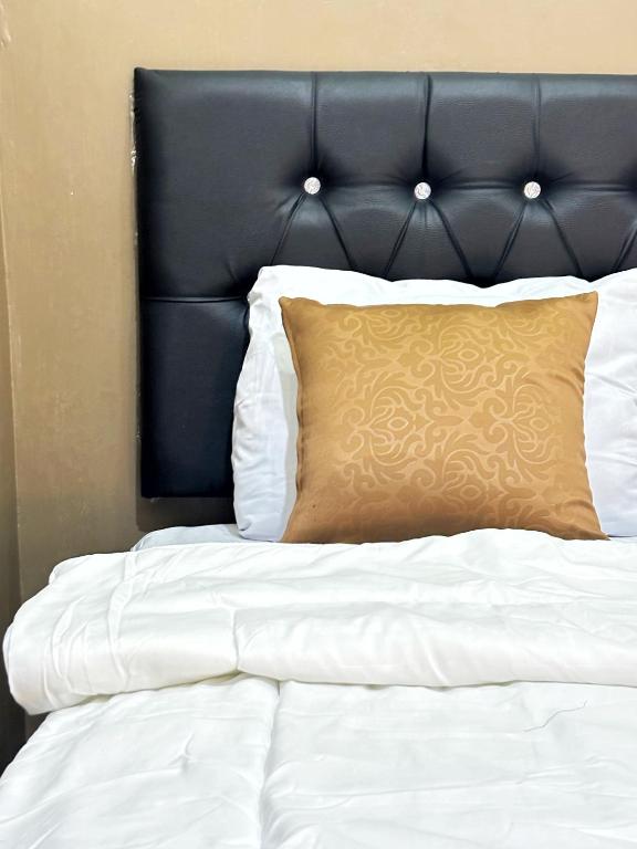 Postel nebo postele na pokoji v ubytování Griya Inn