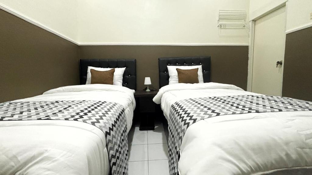 Postel nebo postele na pokoji v ubytování Griya Inn