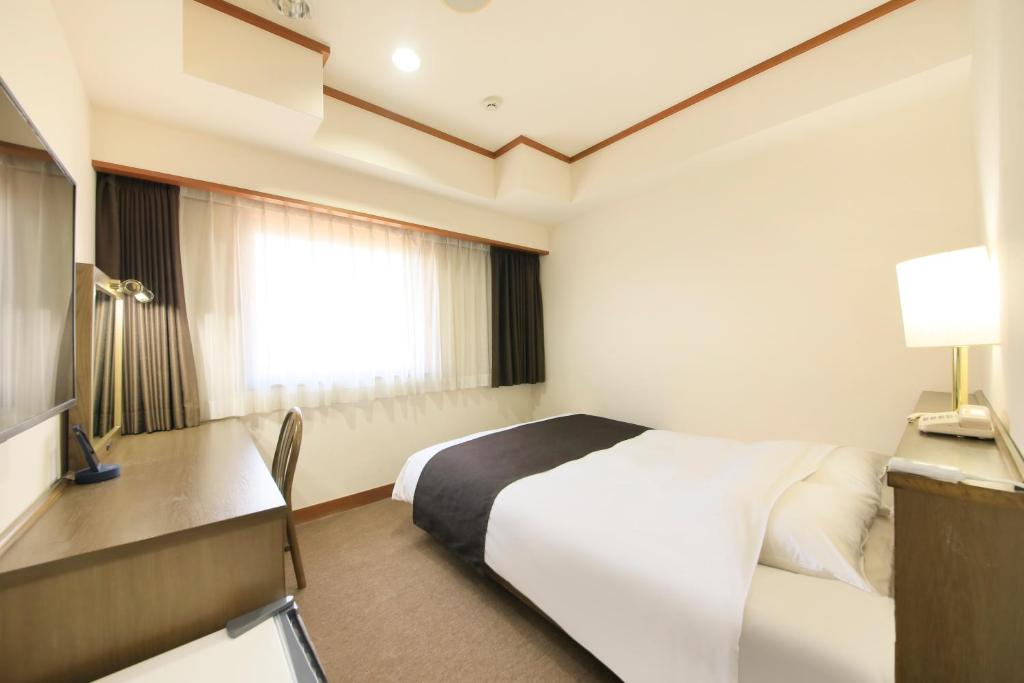 Postel nebo postele na pokoji v ubytování Maple Inn Makuhari