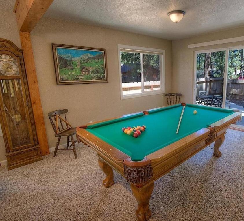 a pool table in a living room with afits at Corner Pocket Chalet home in South Lake Tahoe