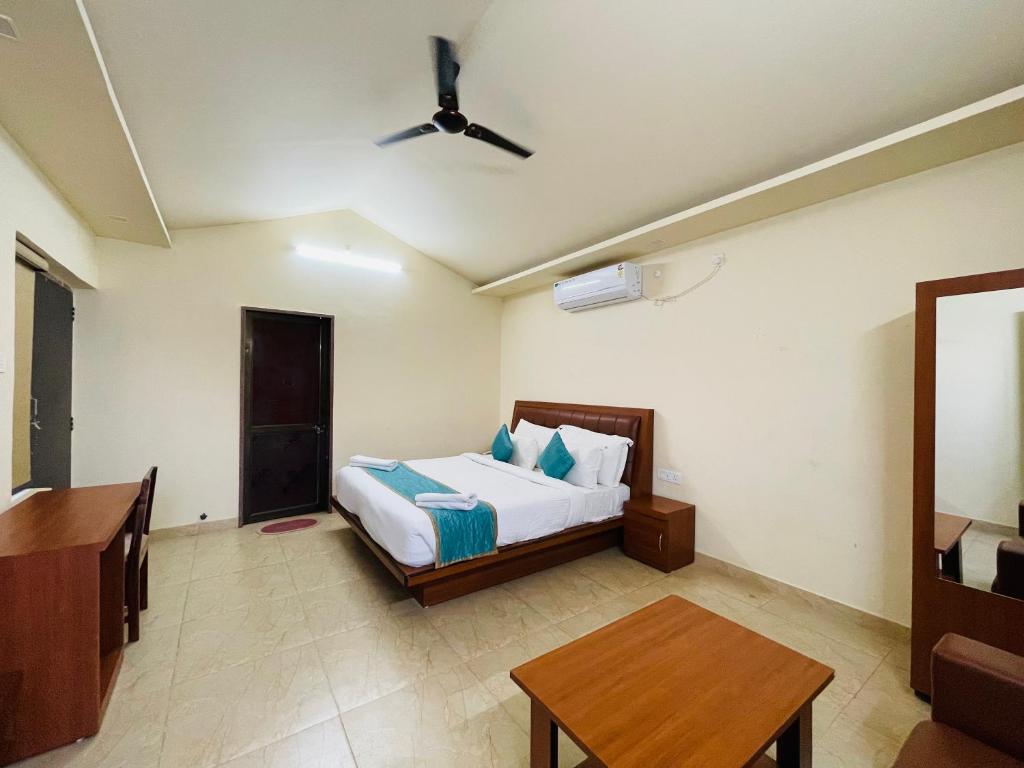 a bedroom with a bed and a table in it at S K Pushkar Resort in Pushkar