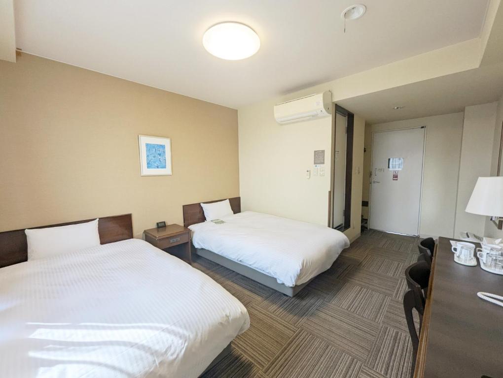 Postel nebo postele na pokoji v ubytování Hotel Route-Inn Court Shinonoi