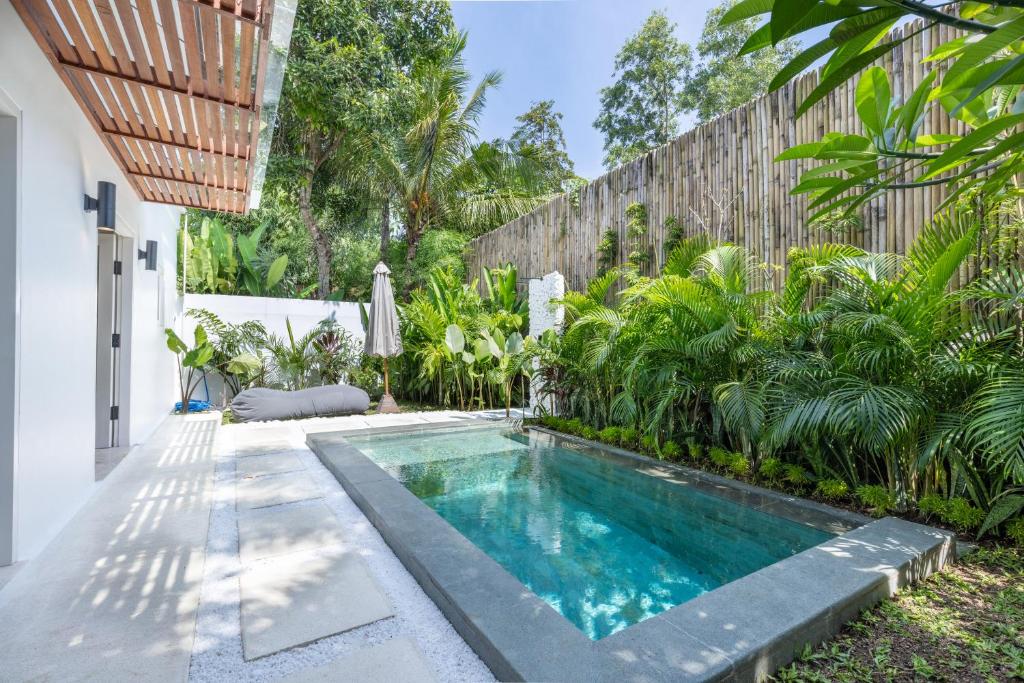 a swimming pool in the backyard of a house at Villa Dua Nomada in Kuta Lombok