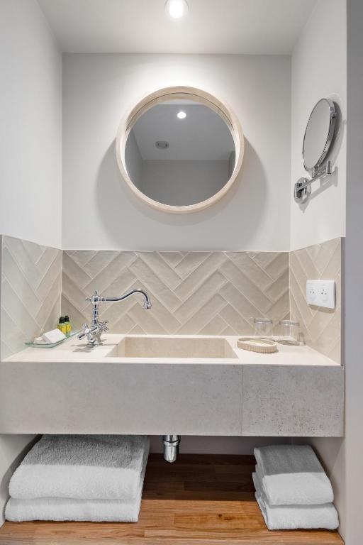 a bathroom with a sink and a mirror at Hôtel La Villa Sainte Valérie Adults Only in Juan-les-Pins