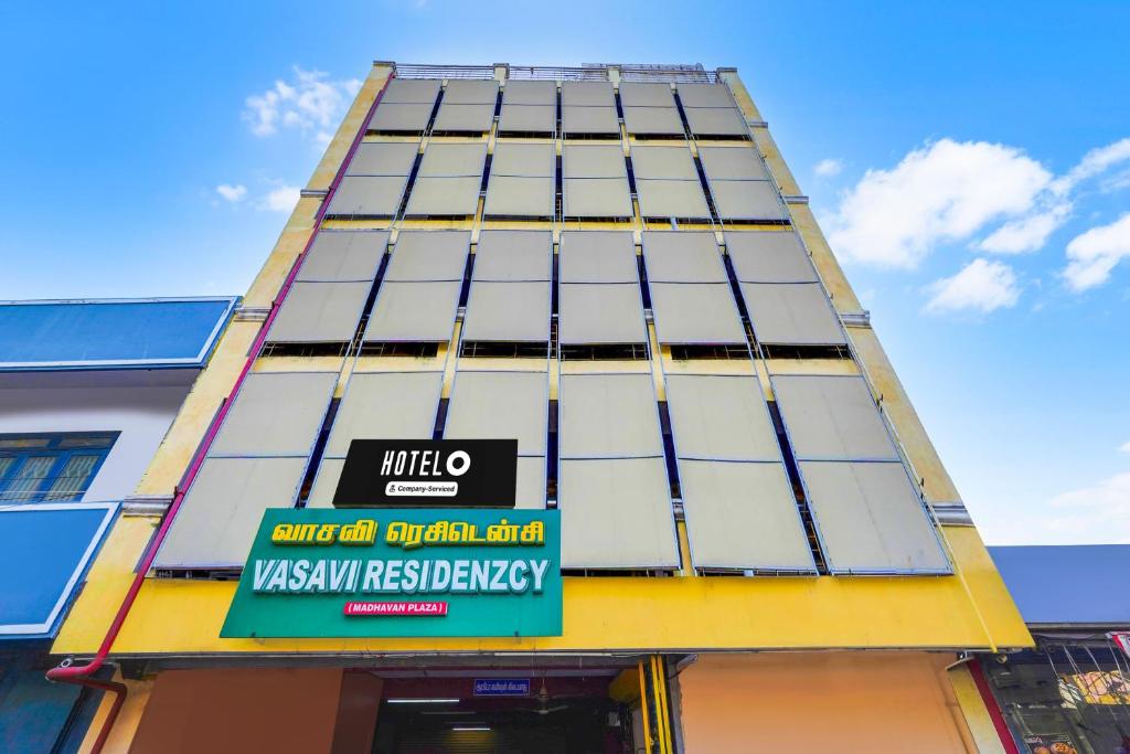 a tall yellow and white building with a sign on it at Super Hotel O Heritage Town Formerly Vasavi in Puducherry