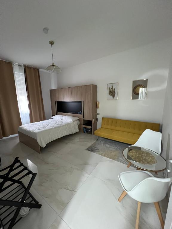 a bedroom with a bed and a couch and a table at Lupo Luxury Rooms in Bologna