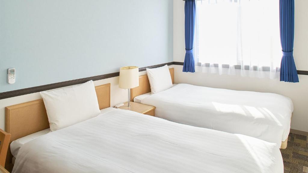 Postel nebo postele na pokoji v ubytování Toyoko Inn Nagoya Marunouchi