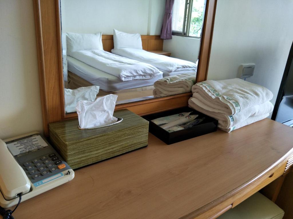 Postel nebo postele na pokoji v ubytování 復興青年活動中心 復興比雅山會館
