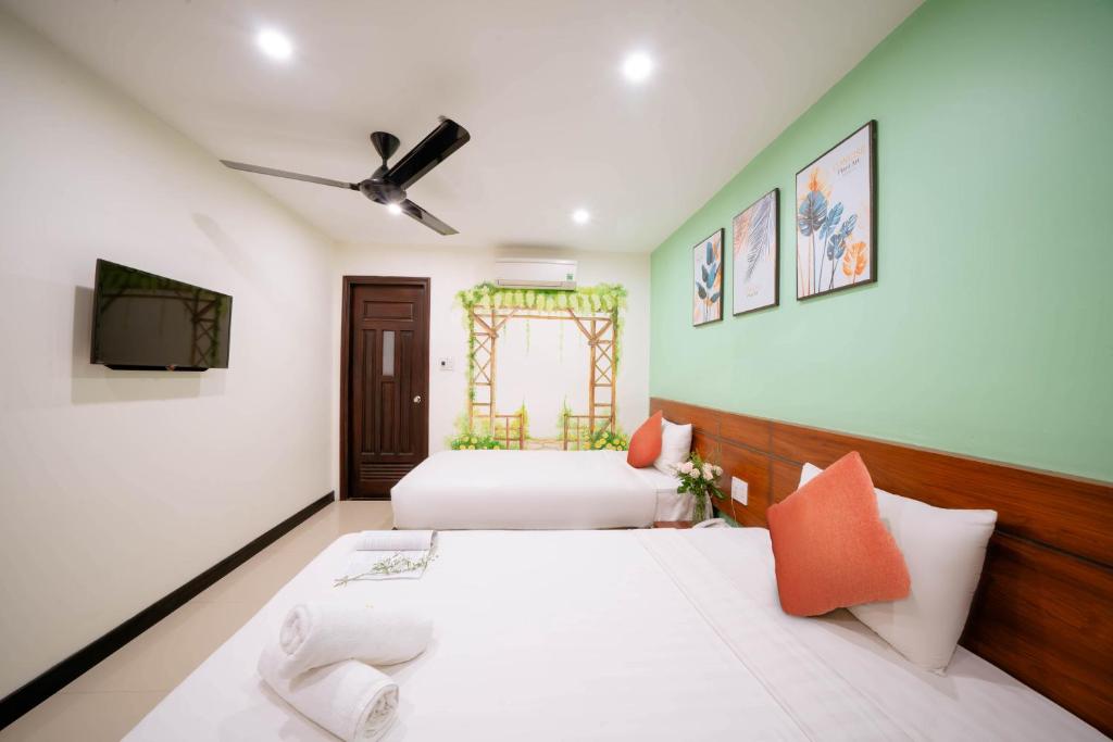 Postel nebo postele na pokoji v ubytování Quoc Cuong Center Da Nang Hotel by Haviland