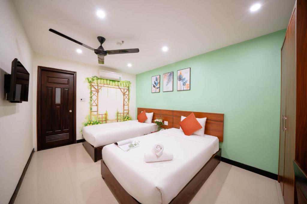 Postel nebo postele na pokoji v ubytování Quoc Cuong Center Da Nang Hotel by Haviland