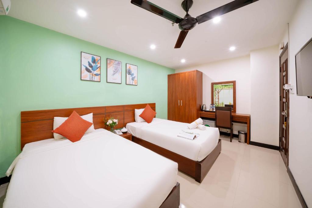 Postel nebo postele na pokoji v ubytování Quoc Cuong Center Da Nang Hotel by Haviland